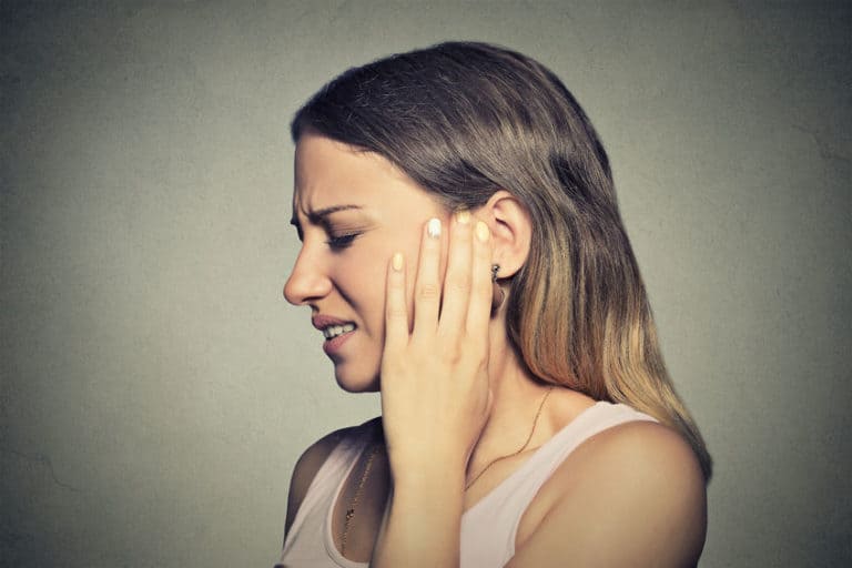 woman with hearing aid pain